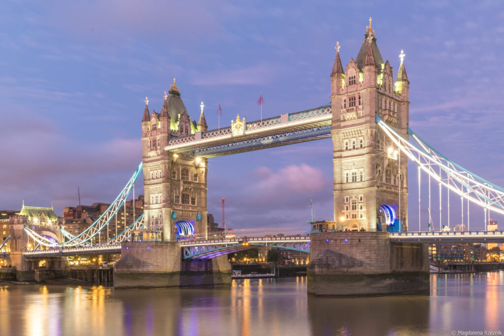 tower bridge surrounded by buildings lights evening london uk 1